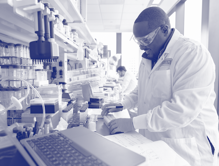 “Blue duotone image of Jnana scientist in the lab examining and labeling samples