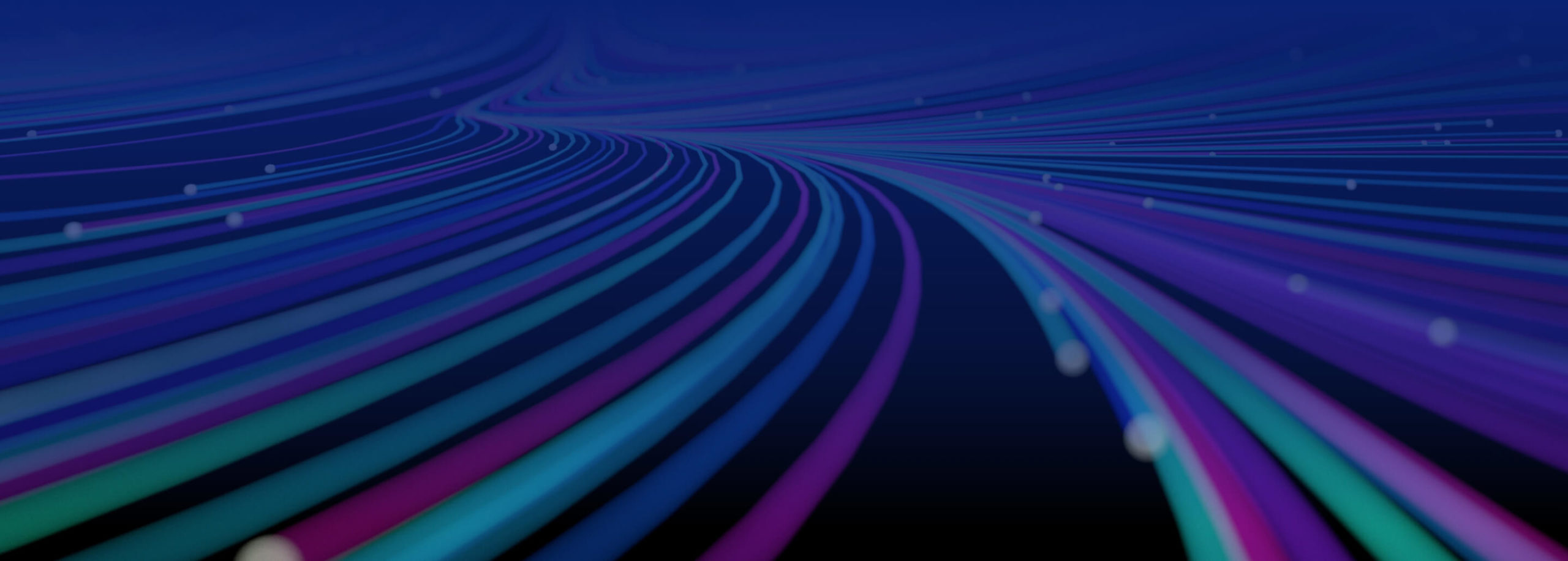 Zoomed out, unfocused image of abstract glowing spiral lines of bright purple, green and blue.